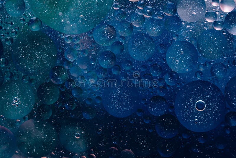 Water oil bubble macro abstract background flow liquid dark blue aqua black colors space planets stars