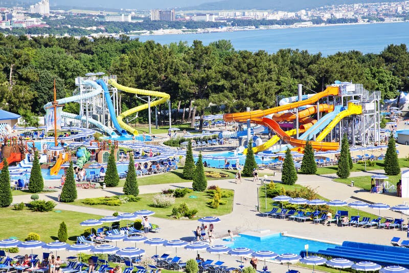 Water Park on the beach on a Sunny morning. Rides in the form of spiral pipes. There are channels with running water at the bottom. Striped blue umbrellas royalty free stock photography Water Park on the beach on a Sunny morning. Rides in the form of spiral pipes. There are channels with running water at the bottom. Striped blue umbrellas royalty free stock photography