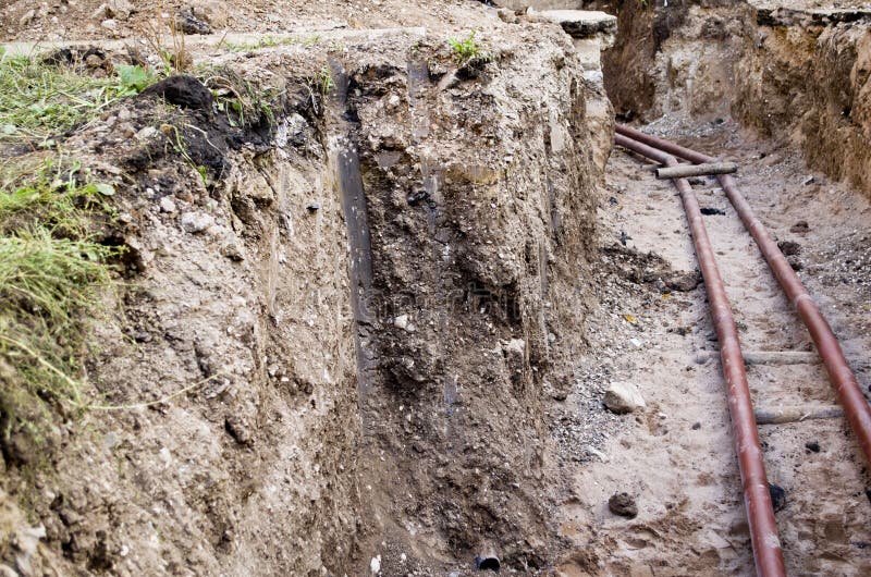 A water pipe in the trench stock photo. Image of ground 59554006