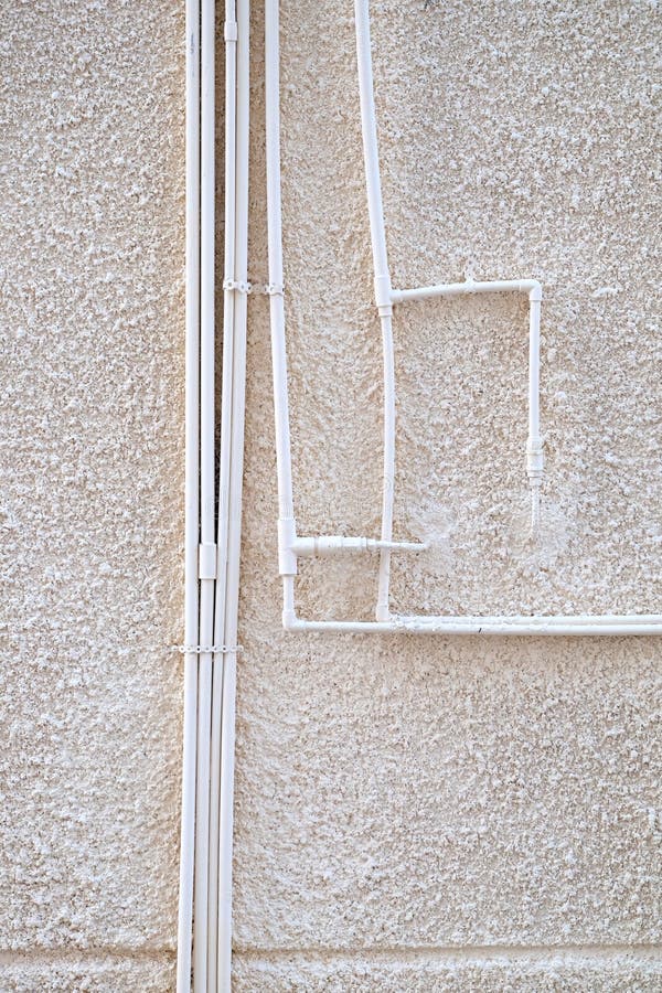 Water Pipes are Fixed on the Outer Side of the Stone Wall of the House