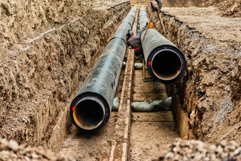 Water Pipes in Ground Pit Trench Ditch during Plumbing Under