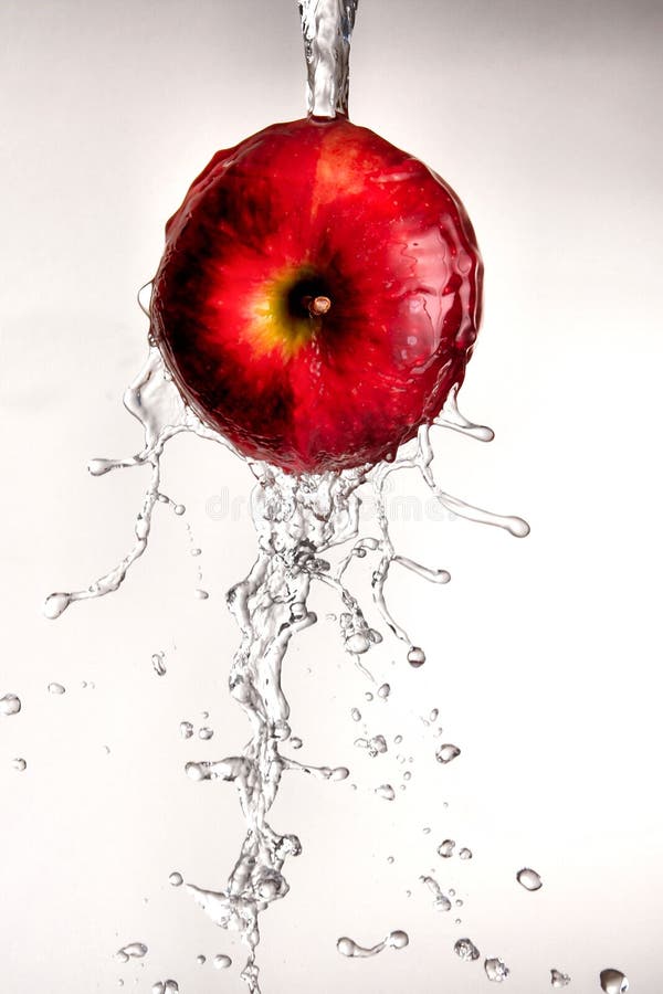 Water pouring off red apple.