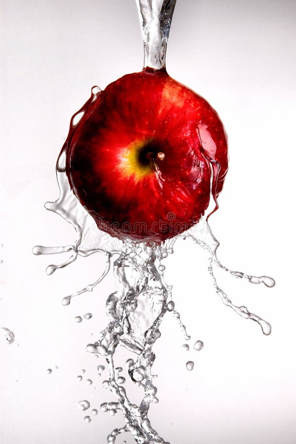 Water pouring off red apple.