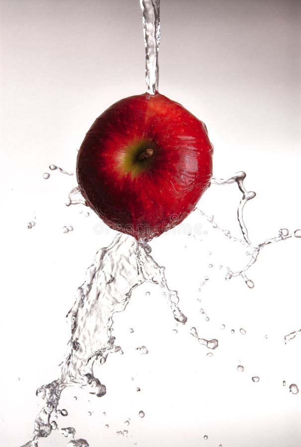 Water pouring off red apple.