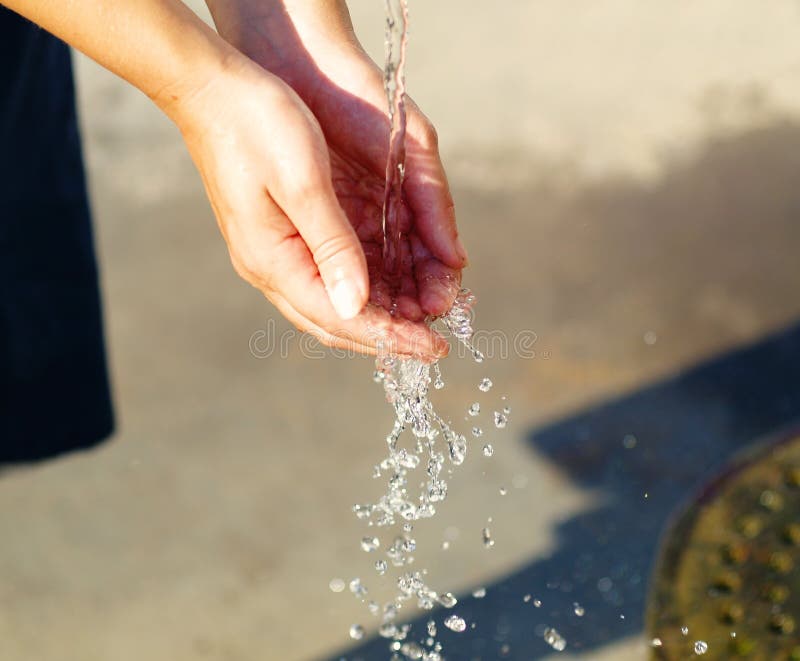 Water Pouring On Person's Hand Picture. Image 82931602