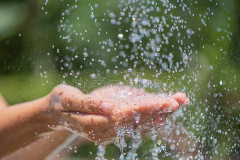 Water pouring in woman`s hands. World Water Day concept. stock image Water pouring in woman`s hands. World Water Day concept. stock image
