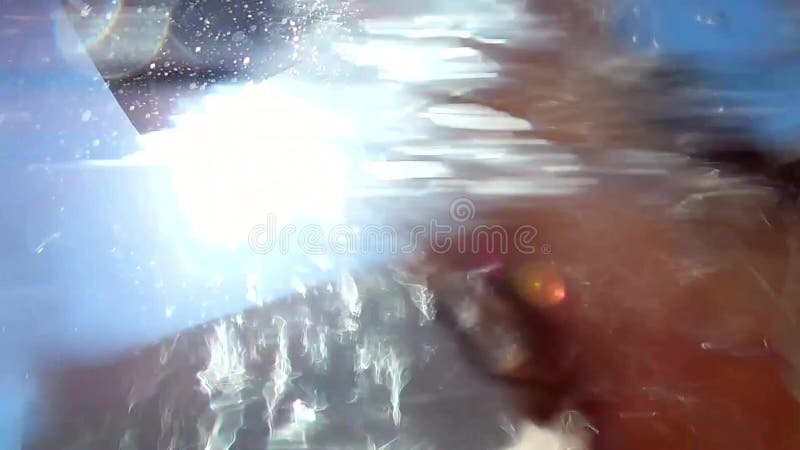 Water pours from a beach street shower on a young attractive happy woman, girl, slow motion.