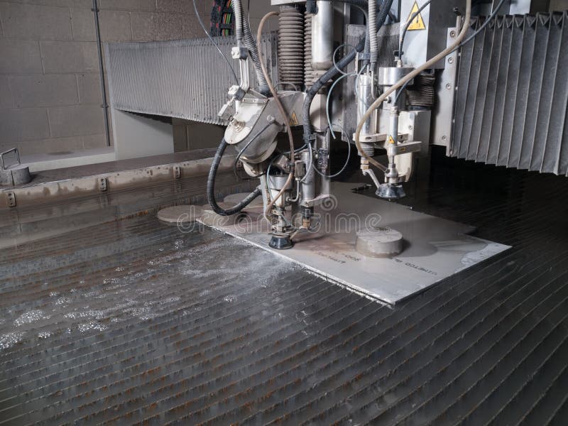 Water Pressure Cutting through Stainless Steel Materials Stock Photo