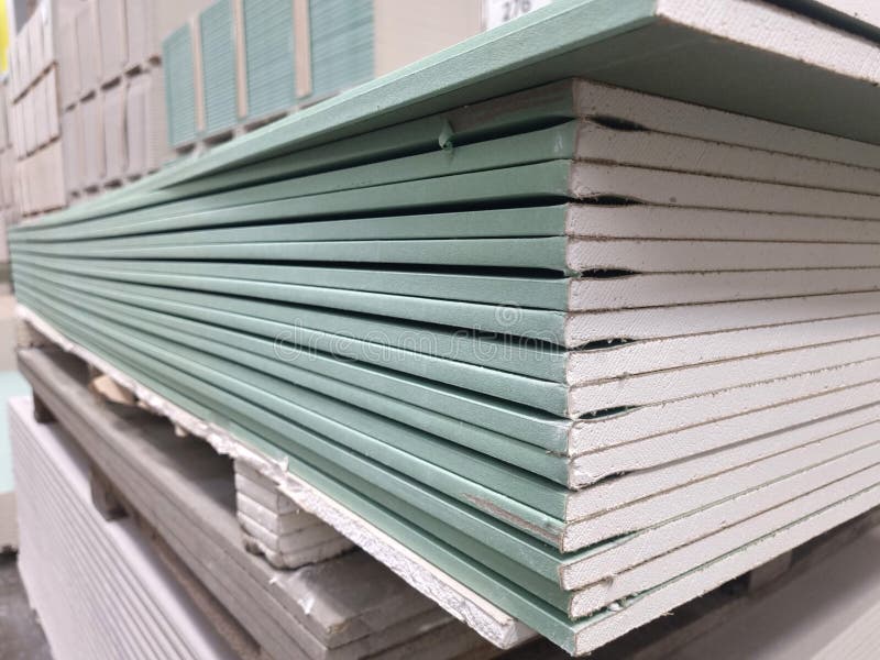 Water resistant plasterboard sheets stacked in a hardware store. dry gypsum plaster. building material for the arrangement of cladding, partitions, ceilings in buildings.