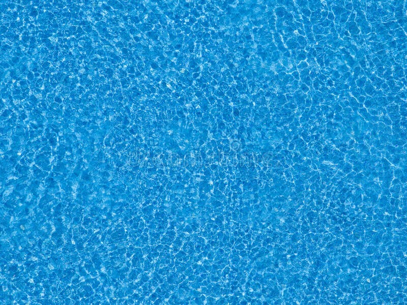 Water ripples on blue tiled swimming pool background.