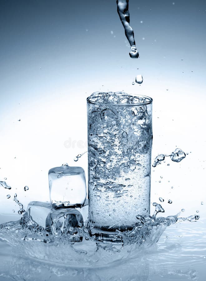 Glass of water. Glass of cold water with splash and dew drops