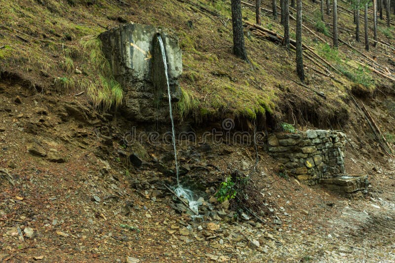 Water spout on the slope of the mountain