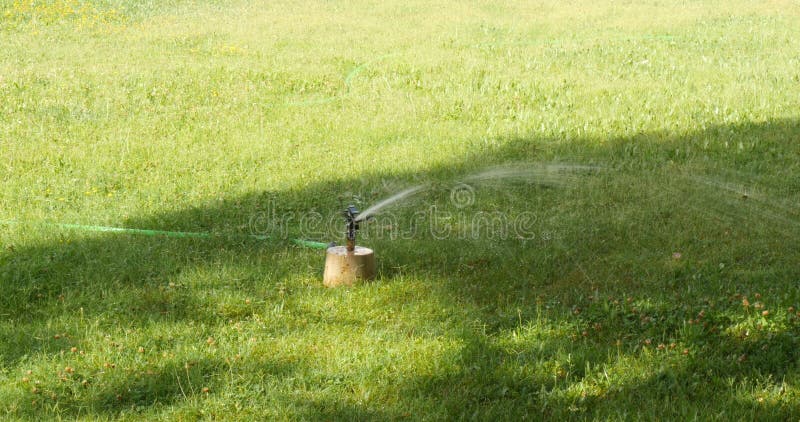 Water Sprinkler watering grass in the garden. Lawn sprinkler. irrigation system royalty free stock image Water Sprinkler watering grass in the garden. Lawn sprinkler. irrigation system royalty free stock image