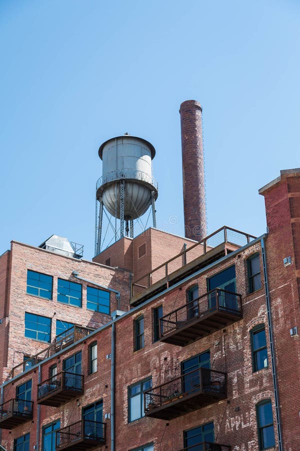 Water Tower on Old Brick Building with Metal Balconies