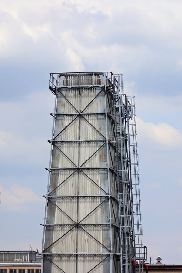 The water tower is steel construction protected by slate. Construction technology. Industrial architecture. Working space.