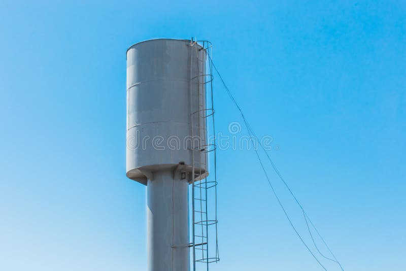 Water tower water storage tank at a height against the blue sky
