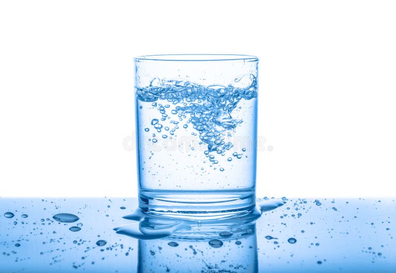 Water in transparent glass with drops and bubbles isolated over