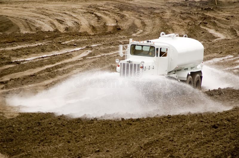 Water Truck Sprays Water for a New Road Construction Site Stock Image