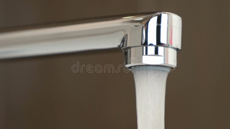 Water under strong pressure flows from a water tap