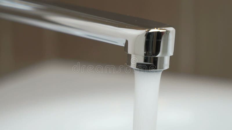 Water under strong pressure flows from a water tap