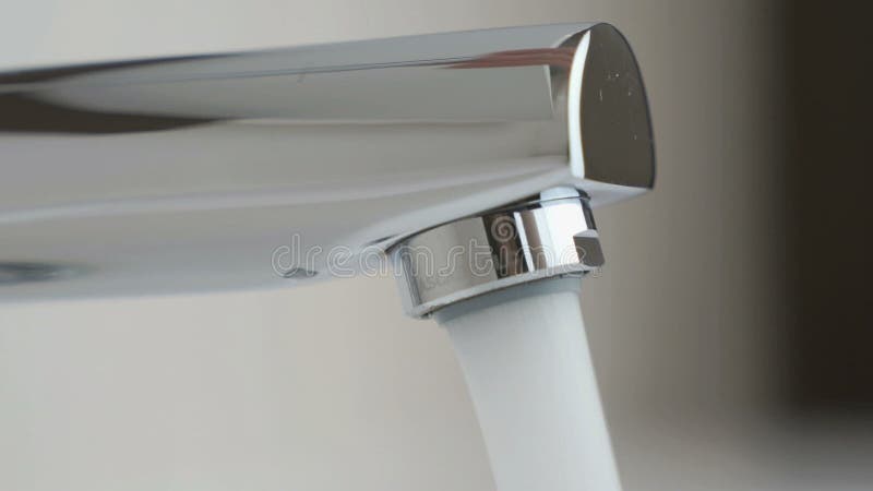 Water under strong pressure flows from a water tap