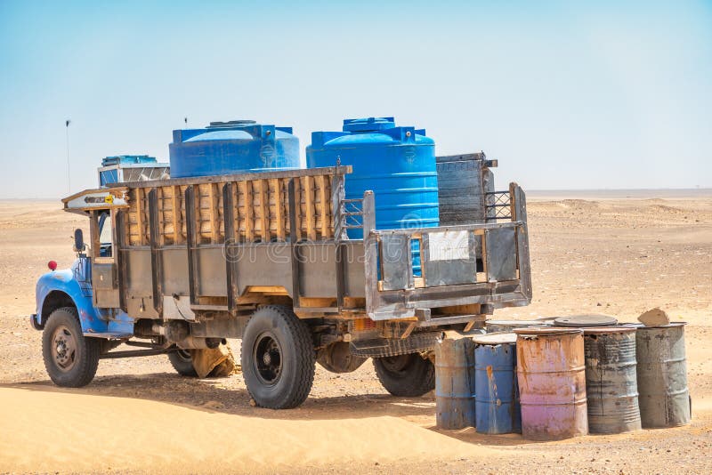 Water wagons and water barrels in the middle of the desert of Sudan, Africa