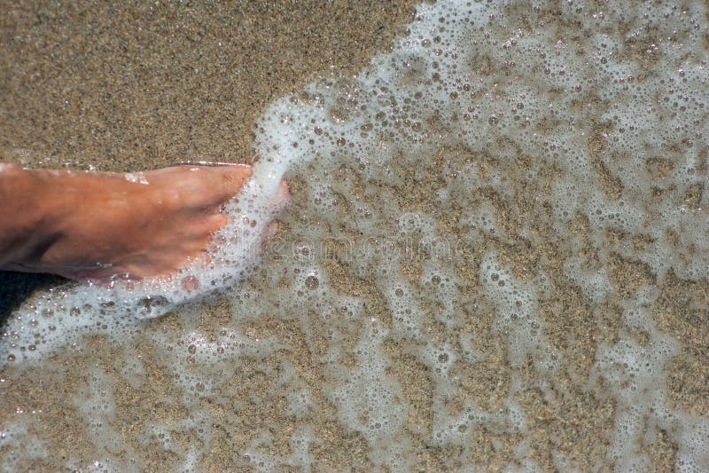 Water washes the foot, the beach, cold water in the sea stock images Water washes the foot, the beach, cold water in the sea stock images