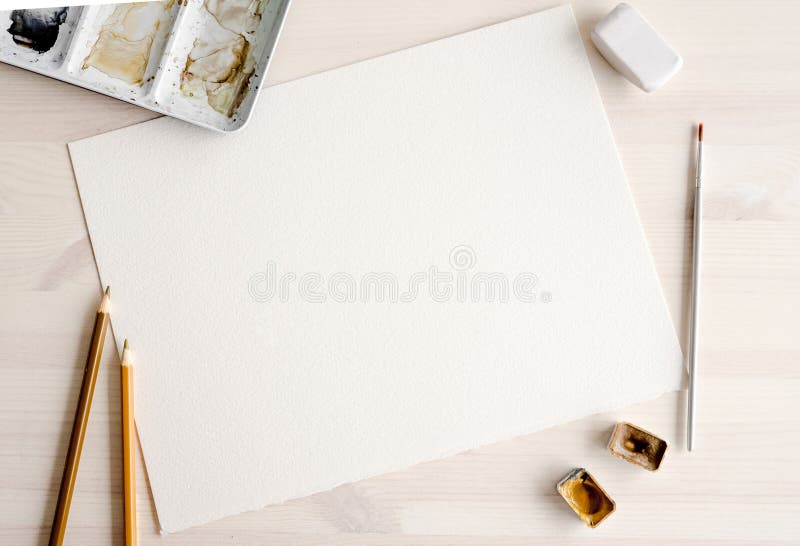 Watercolor paper blank with paint pallete and brush. Artist set. Aquarelle drawing canvas template with copy space and paintbrush for craft hobby