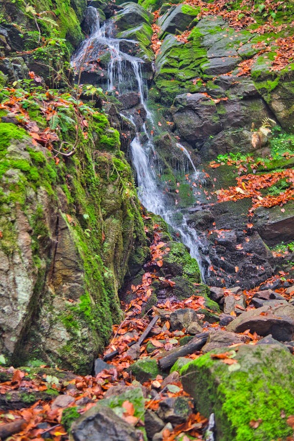 Waterfall in creek in Turovska roklina gorge during autumn in Kremnicke vrchy mountains