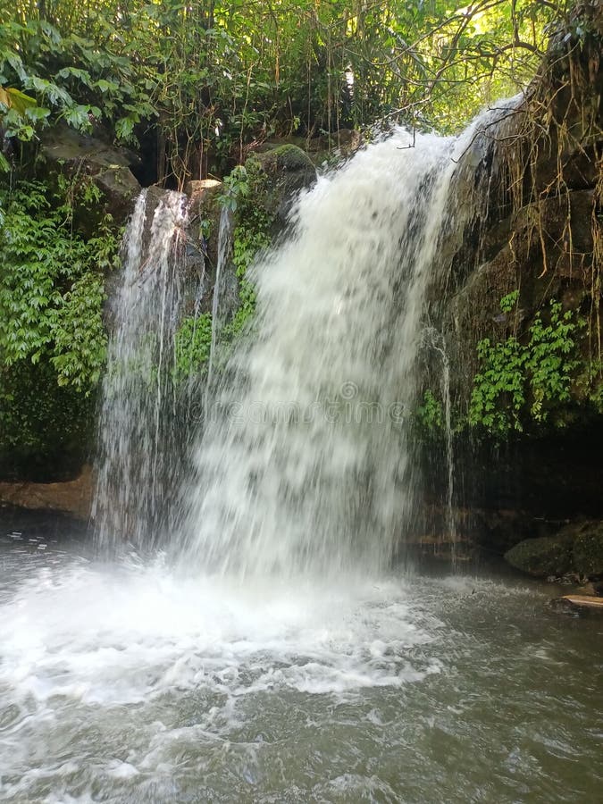 Waterfall in the middle of a lush forest with clear water. Fountain waterfall clear stock images, royalty-free photos and pictures