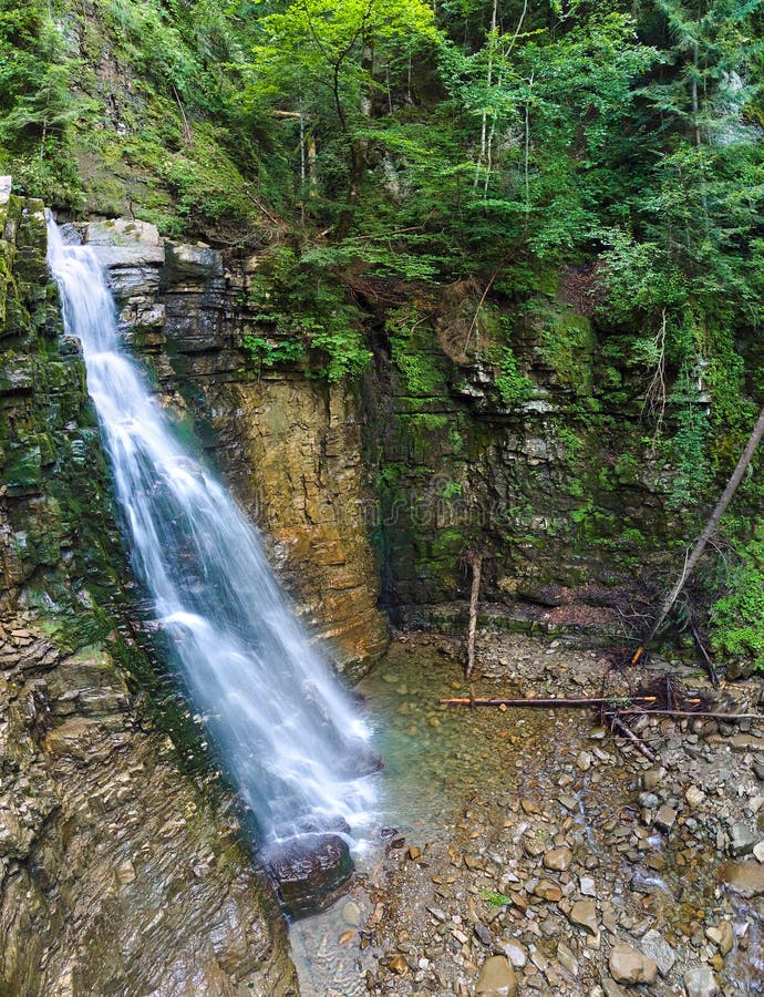 Waterfall on Mountain River with White Foamy Water Falling Down from