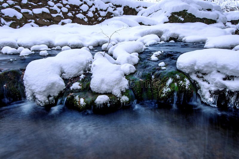 Waterfall and river on the forest in winter.