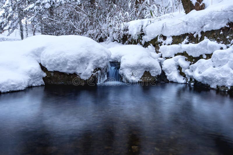 Waterfall and river on the forest in winter.