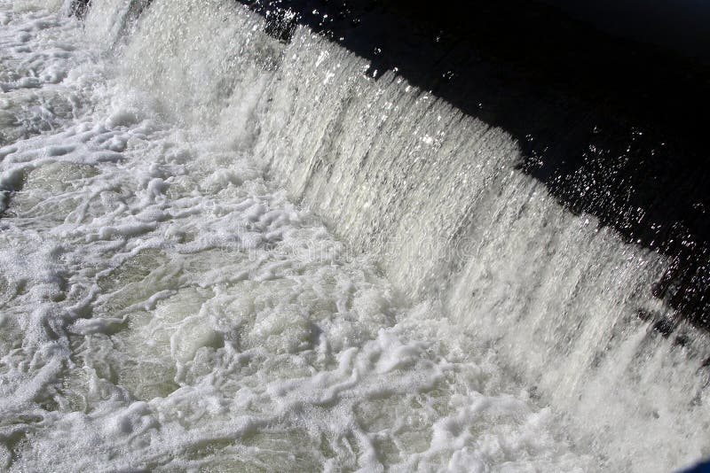 Water Boiling in the River and Foam Due To a Waterfall Stock Photo