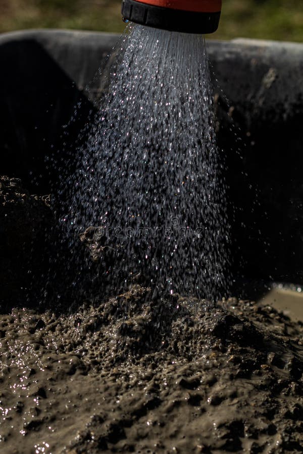 Watering cement mixture stock photo. Image of mixture - 179051856