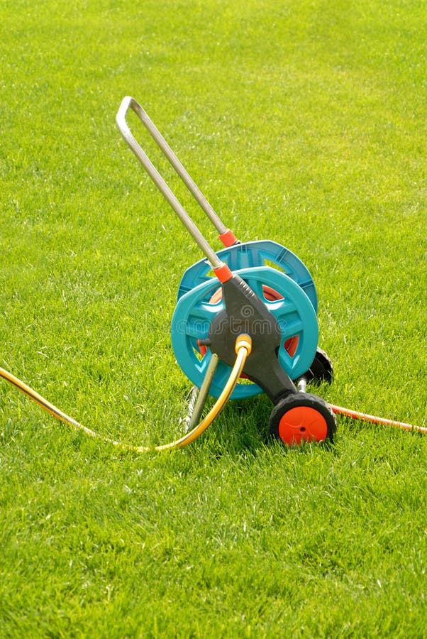 Watering Garden Hose on a Green Grass Stock Photo Image of summer