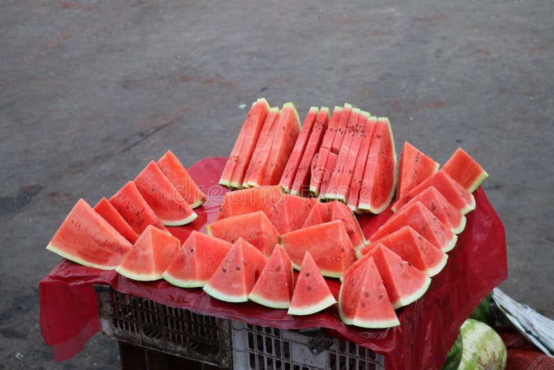 Watermelon cut into triangular pieces, put together. the smooth green skin with red pulp and watery juice. Triangular cut watermelon stock images, royalty-free photos and pictures