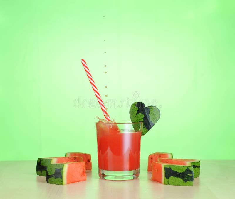 Watermelon juice in glass, straw and heart form stock photography