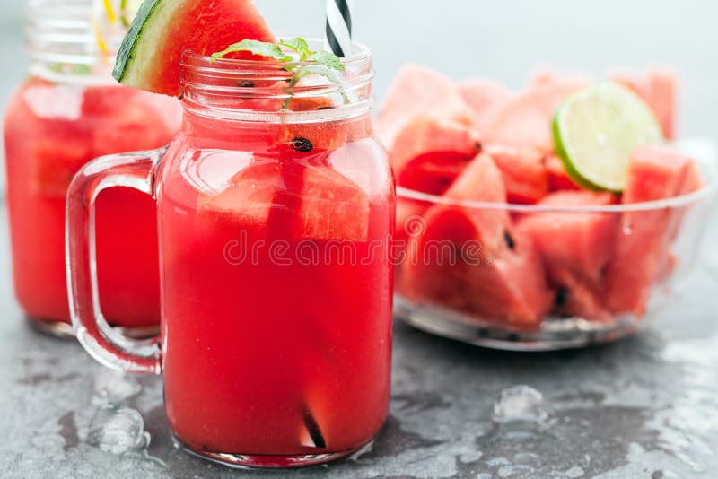 Watermelon juice and slices with lime royalty free stock photography