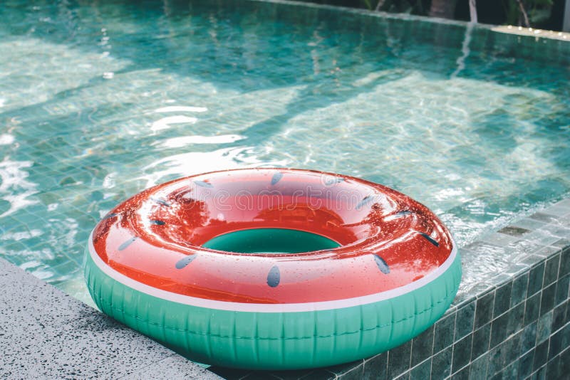 Watermelon pool float, ring floating in a refreshing blue swimming pool Inflatable ring floating in swimming pool stock photos Watermelon pool float, ring floating in a refreshing blue swimming pool Inflatable ring floating in swimming pool stock photos