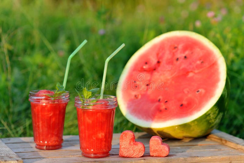 Watermelon red smoothie as healthy summer drink. Bio organic and vegan beverage with hearts. royalty free stock photos Watermelon red smoothie as healthy summer drink. Bio organic and vegan beverage with hearts. royalty free stock photos