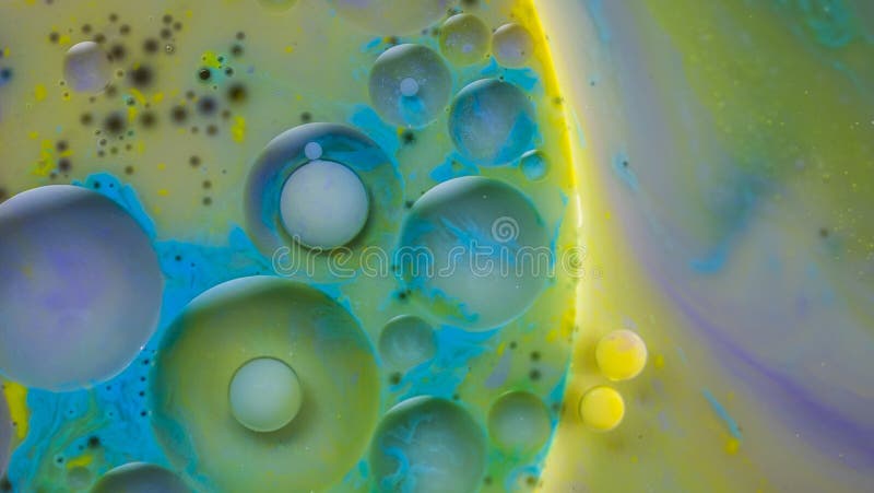 Waterpaint and oil mixing experiments. Magic, colourful and beautiful effect. Color Bubbles in the abstract environment. Waterpaint and oil mixing experiments. Magic, colourful and beautiful effect. Color Bubbles in the abstract environment