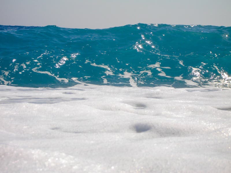 Wave breaking on blue sky royalty free stock photography