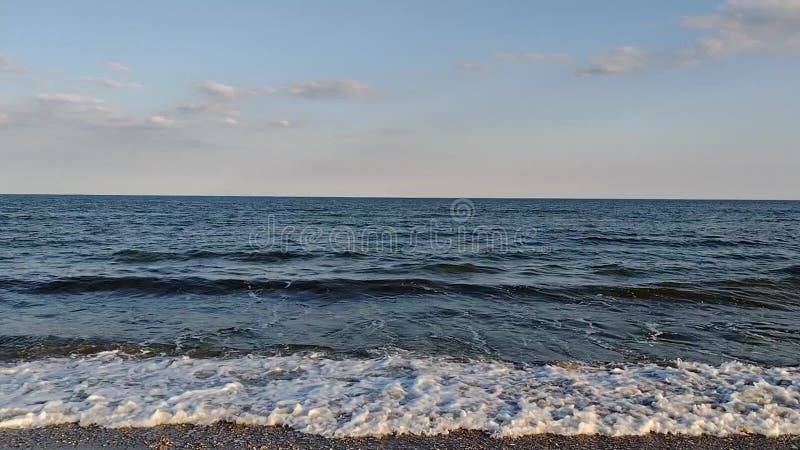 A wave runs on the sandy shore of the sea, mobile video stock footage