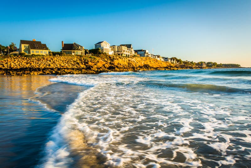 Waves in the Atlantic Ocean and Houses on Cliffs in York, Maine. Stock