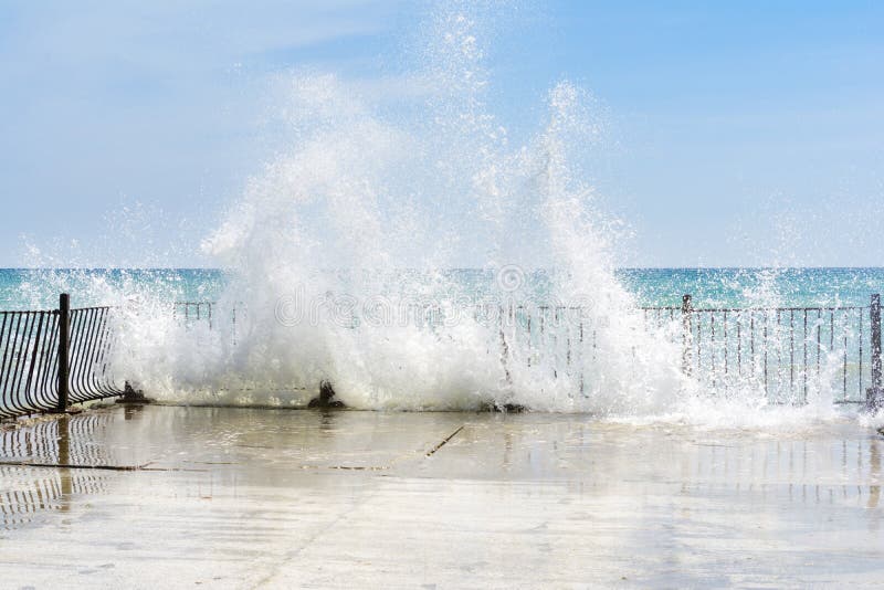 Waves beat against old pier stones on a sunny day. A lot of splashes royalty free stock image Waves beat against old pier stones on a sunny day. A lot of splashes royalty free stock image