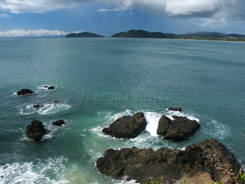 Waves breaking on giant rocks stock image Waves breaking on giant rocks stock image