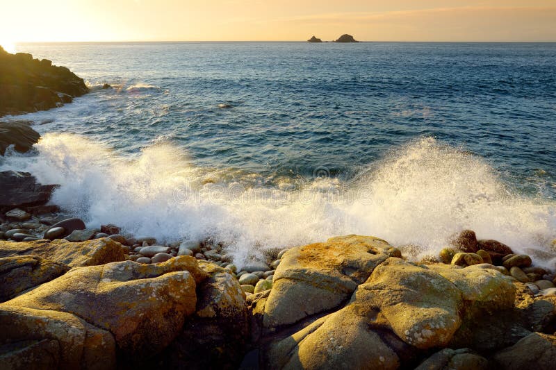 Waves breaking on a rocky beach over Porth Nanven in the Cot Valley of Cornwall, England
