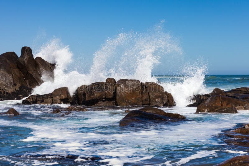 Waves crashing against boulders