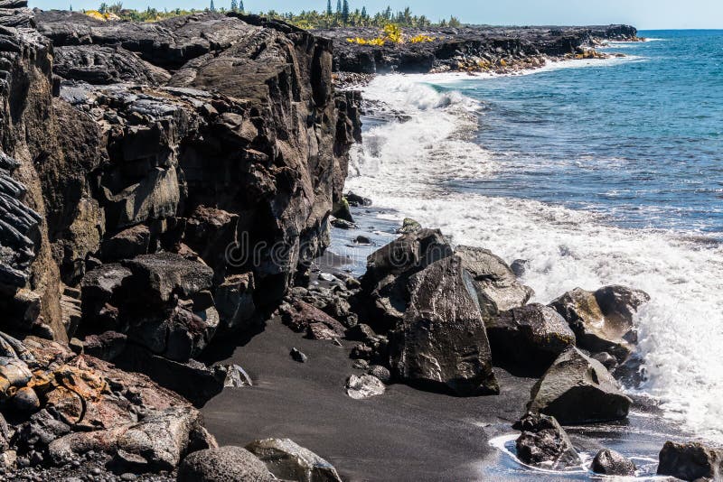 Waves Crashing Against Sea Cliffs Formed by Recent Lava Flows on Kaimu Black Sand Beach, Hawaii Island, Hawaii, USA. Waves crashing cliffs stock images, royalty-free photos and pictures